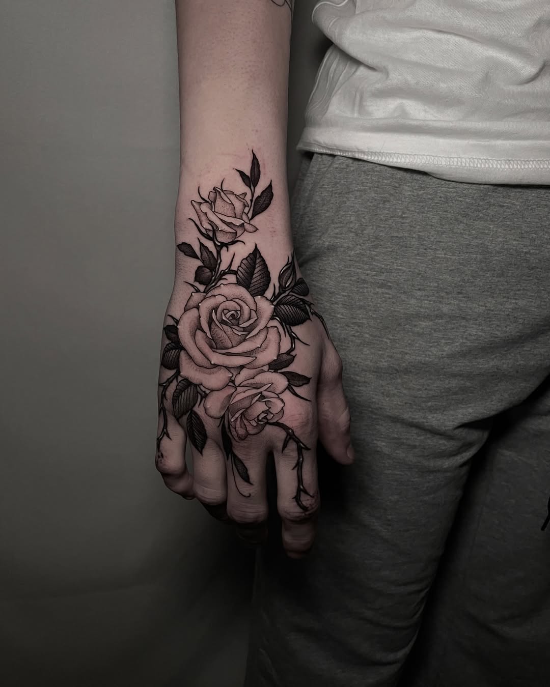 27 Rose Hand Tattoo Ideas: From Classic Black-and-Gray to Bold Narrative Pieces