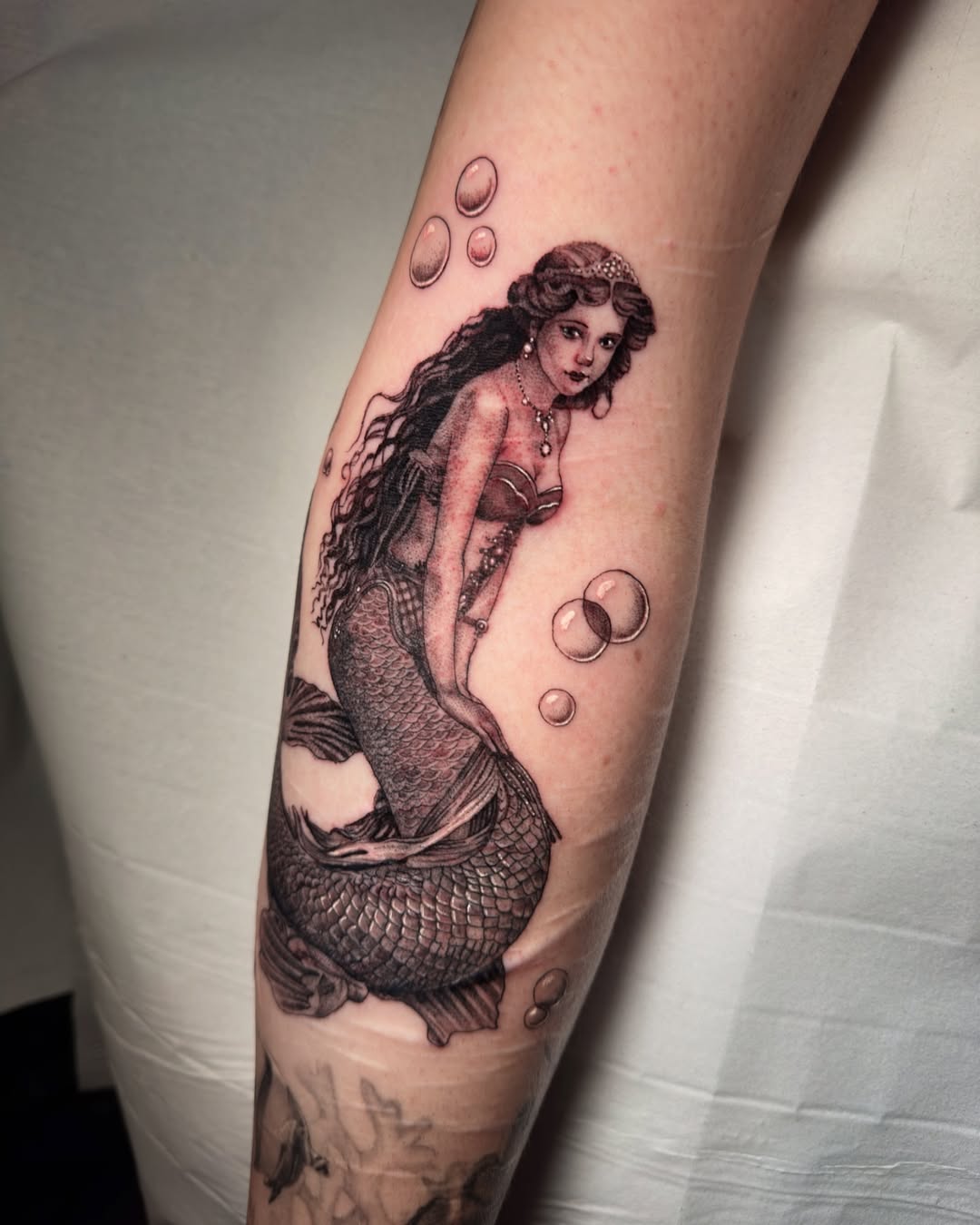 27 Mermaid Tattoo Ideas With Minimalist, Traditional, Afro, Siren, and Barbie-Inspired Designs